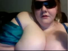 On the camera is a skanky, fat white harlot wearing sunglasses.